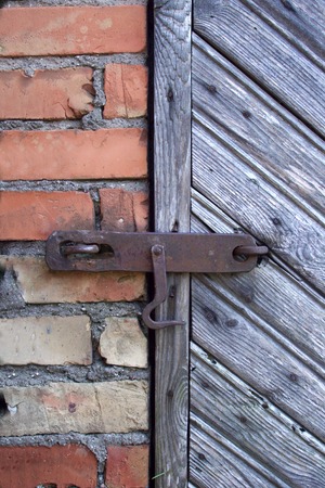 lock on the door of an old farmhouse . true village style .の写真素材