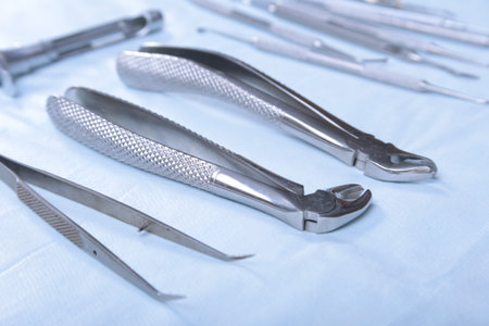Medical instruments for dentists on blue table.