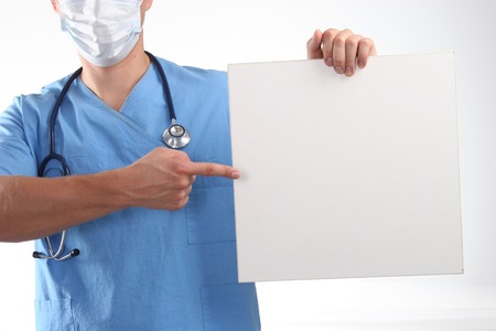 Male doctor showing empty space white placard.の写真素材