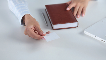 Hand showing a blank business card. Womenの写真素材
