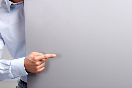 Businessman hold with white card board banner.の写真素材