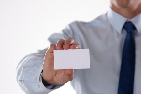 Unknown busineness man with card on white background.の写真素材