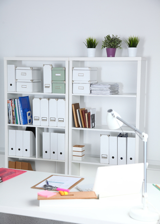 Modern office interior with tables, chairs and bookcasesの写真素材