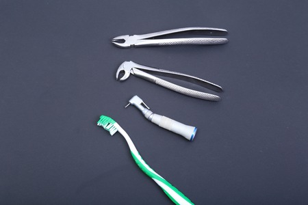 dental care toothbrush with dentist tools on black background.の写真素材