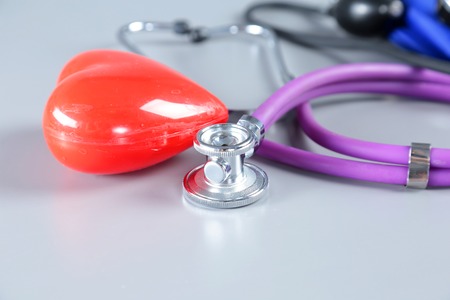 Red heart and a stethoscope on white backgroundの写真素材