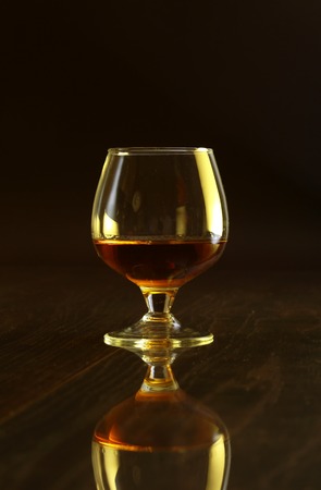 Glasses with white wine and cognac or whisky on mirror table. Celebrities composition.の写真素材