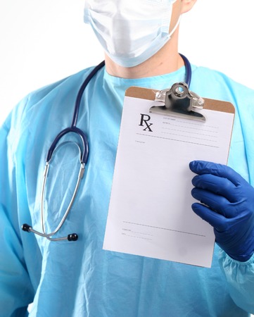 Male doctor standing with folder, isolated on white backgroundの写真素材