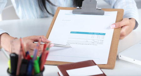 Business women sitting on desk and writing a paper