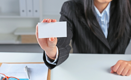 Close-up of business card in women handの写真素材