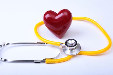 Medical stethoscope and red heart isolated on whiteの写真素材