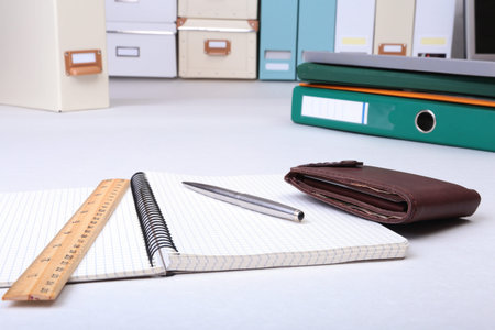 leather wallet with credit cards, Folder file, and note on the desk. blurred background.