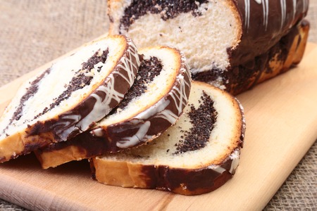 Fresh baked homemade sweet pies, strudel with poppy-seed filling on wooden board.の写真素材