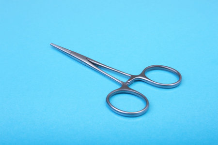 Close Up Surgical instruments and tools on blue mirror background. Selective focus.
