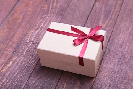 red and gold gift box on wood background.の写真素材