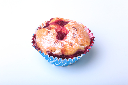 Homemade Blueberry muffins with powdered sugar and fresh berries.の写真素材