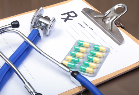 RX prescription, Red heart, asorted pils and a stethoscope on white backgroundの写真素材