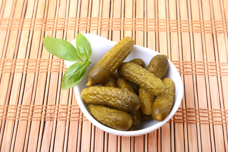 Pickles. Bowl of pickled gherkins cucumber with copy space. Cornichons.の写真素材