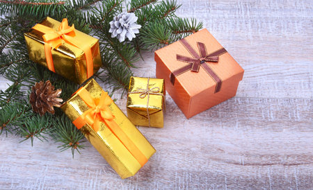 Christmas decoration with gift boxes, christmas tree on a wooden desktop.