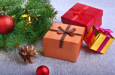 Christmas decoration with gift boxes, colorful christmas balls, christmas tree and cones on a...