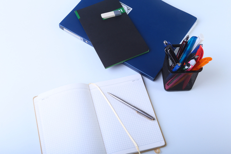 Colorful notebooks and office supplies on white table.の写真素材