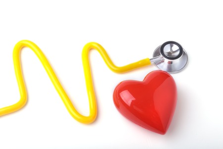 Red heart and a stethoscope on white backgroundの写真素材