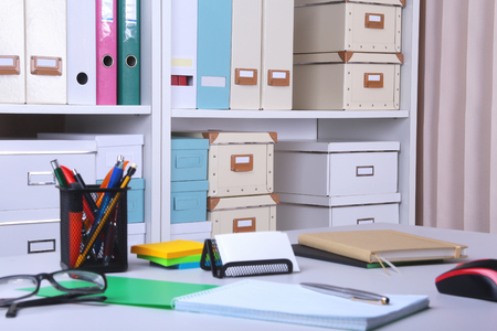 Modern office interior with tables, chairs and bookcasesの写真素材