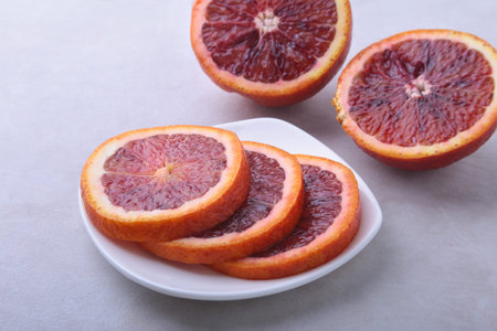 Orange fruit. Orange and lemon slice on white plate. Top view.