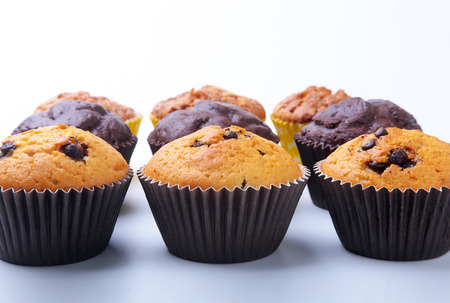 Assorted with Delicious homemade cupcakes with raisins and chocolate isolated on white background. Muffins. Top view.の写真素材