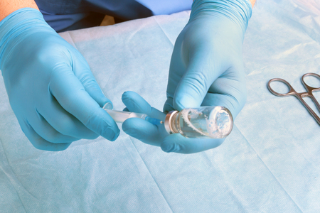 Medical injection in hand. Doctor holding medical injection syringeの写真素材
