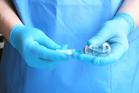 Medical injection in hand. Doctor holding medical injection syringeの写真素材