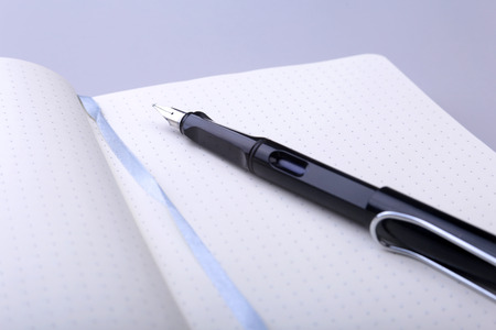 office table with notebook and pen. copy space.の写真素材