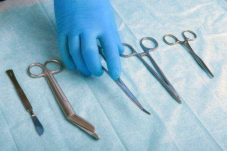 Detail shot of sterilized surgery instruments with a hand grabbing a tool ,