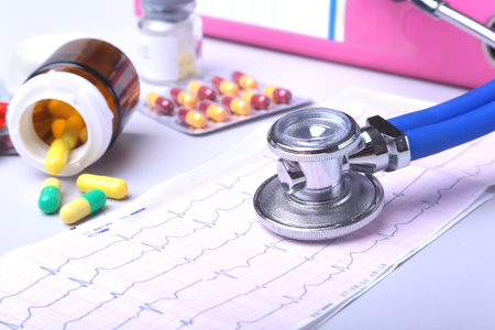 Close-up stethoscope lying on RX prescription with assorted pills. Healthy life or insurance concept.の写真素材
