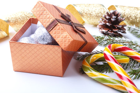 Christmas tree, gift box, lollipop and colored balls on white background. copy space.の写真素材