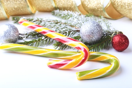 Christmas tree, gift box, lollipop and colored balls on white background. copy space.の写真素材