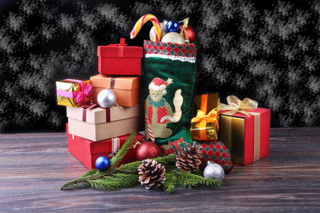 Christmas background. Advent calendar and Santas shoe with gifts on rustic wooden table.