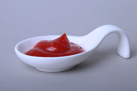 white porcelain bowl of ketchup or tomato sauce isolated on white background.の写真素材