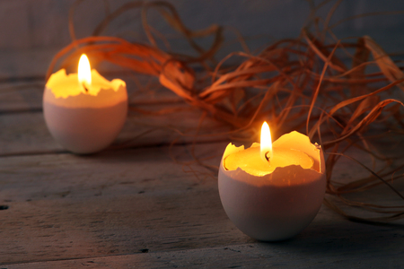 Happy easter composition with eggs and candles on Rustic background. Selective focus.の写真素材