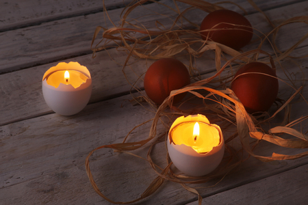 Happy easter composition with eggs and candles on Rustic background. Selective focus.の写真素材