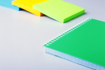 Business concept. Top view of kraft spiral notebook, glasses, smartphone and black pen isolated on background for mockup.の写真素材