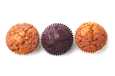 Cupcake, muffin with raisins and chocolate isolated on white background. Delicious homemade Muffins. Top view.の写真素材