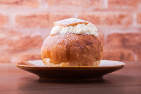 Traditional swedish dessert Semla, also called Shrove bun, with almond paste and whipped cream...