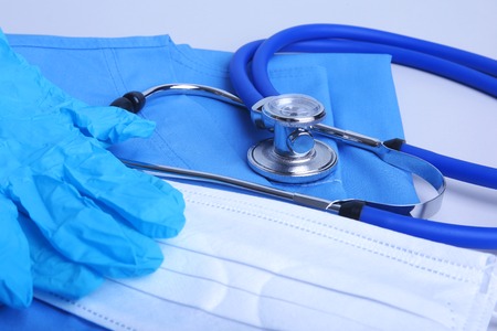Medical stethoscope lying on a blue doctors form and notepad close-up. the therapists work space.の写真素材