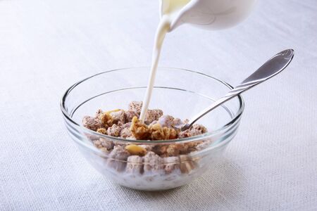 Healthy food with Corn Flakes cereal in a bowl, apple, banana and glass with milk. Morning breakfast.の写真素材