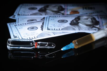 drug trafficking, crime, addiction and sale concept - closeup of with drugs and money.の写真素材