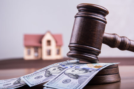 model of house on money dollars with a judges hammer as investment concept mortgage fund finance and...