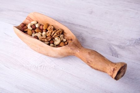 wood serving spoon with Assortment nuts on wooden table. Close-up.の写真素材
