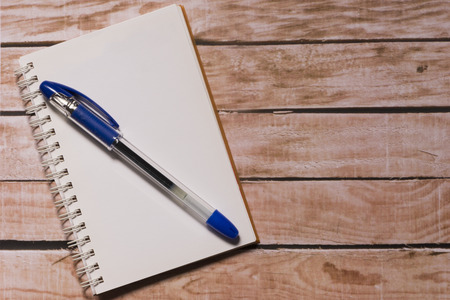 Opened notepad on top of a wooden boardの写真素材