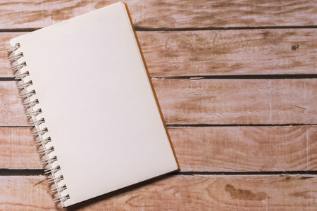 Opened notepad on top of a wooden boardの写真素材