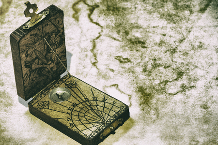 A sundial with a compass in brown backgroundの写真素材
